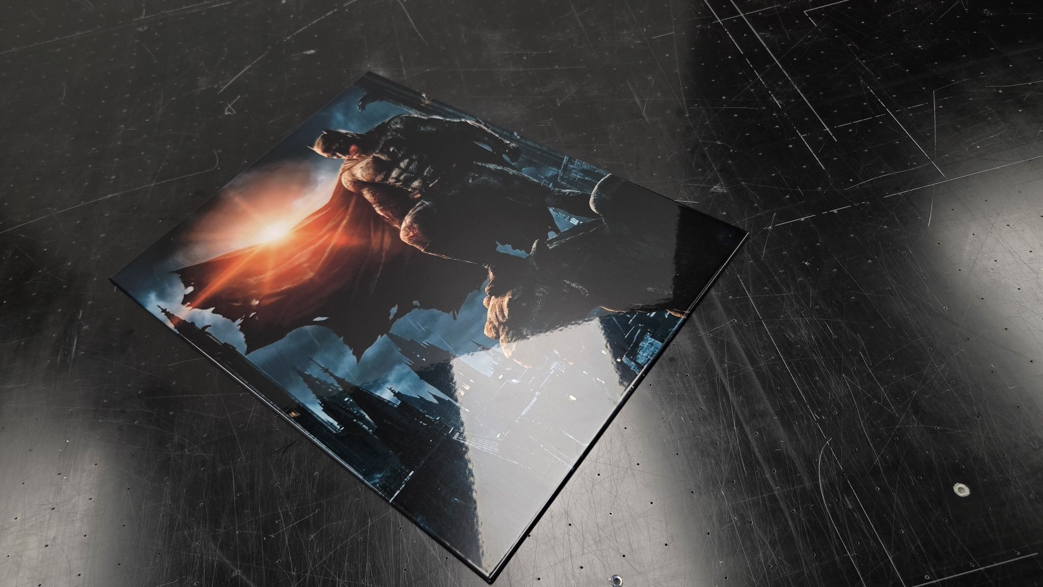 Finished Titan Forge metal panel of Batman on a gargoyle, photographed on the workshop bench